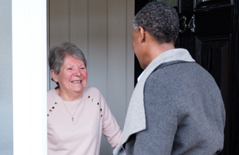client opens door to caregiver