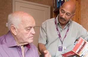 CAREGiver discussing fraud prevention with an elderly man