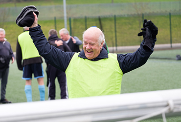 Eldery man celebrating after playing football