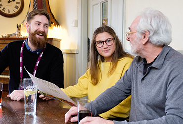 Elderly man and grandaughter out for lunch with CAREGiver