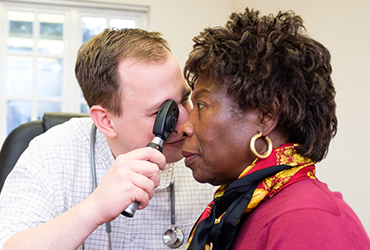Elderly lady having their eyes examined by a optician