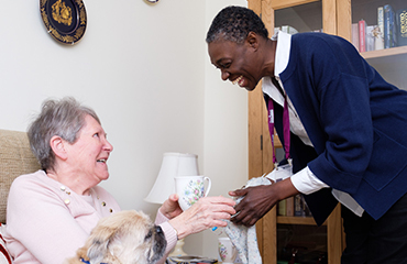 CAREGiver serving an elderly lady tea