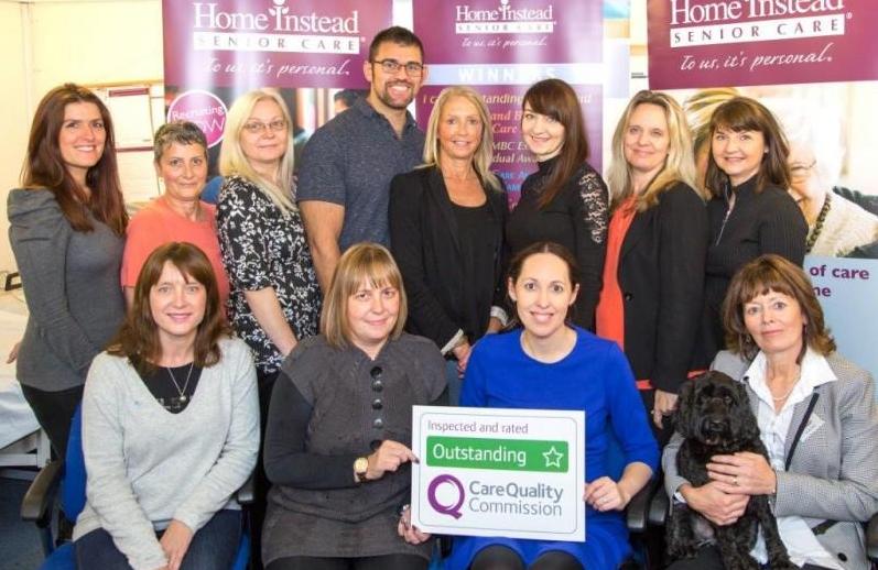 office group photo with CQC 'Outstanding' award