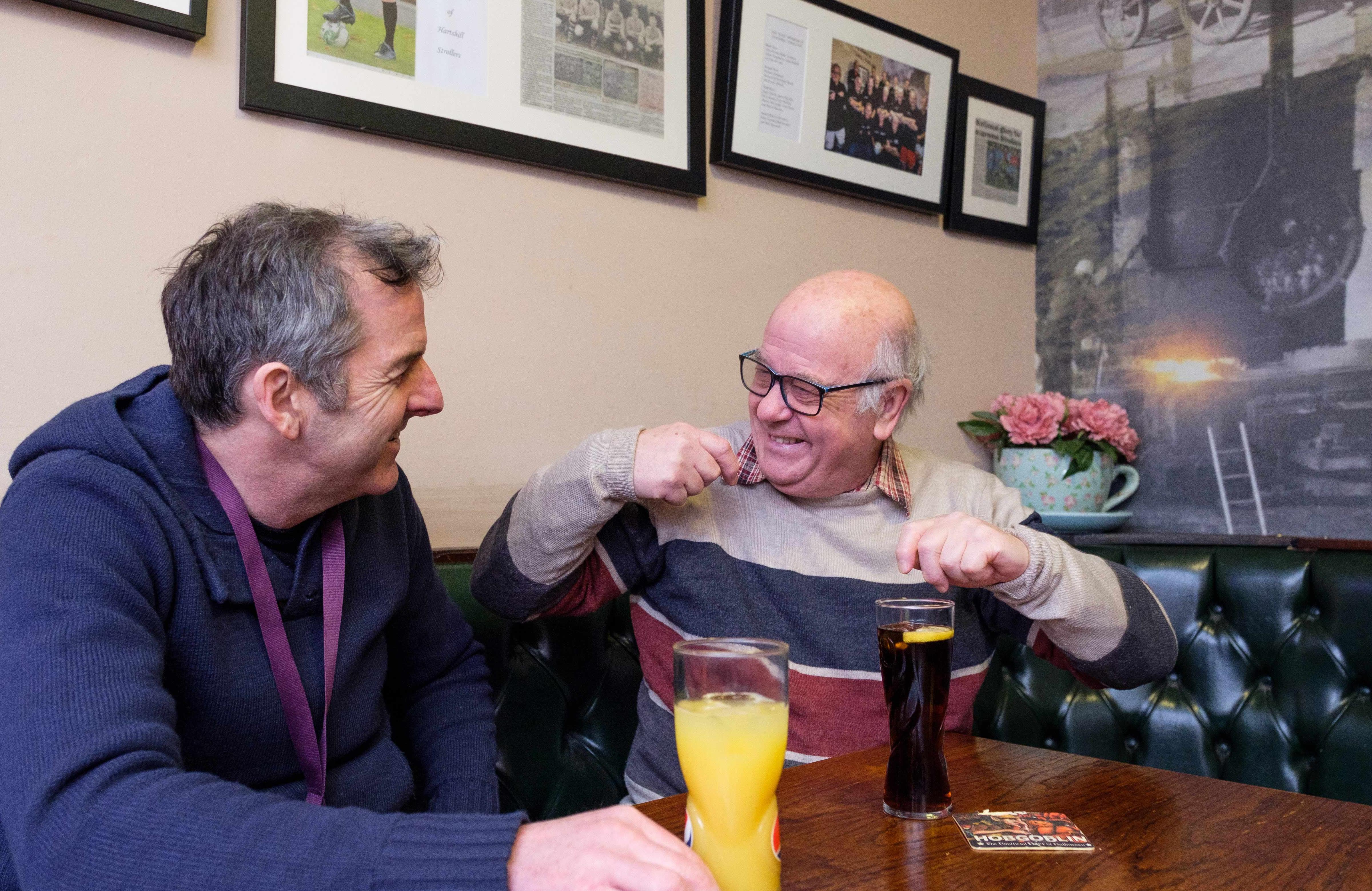 elderly man has a drink with Rotherham CAREGiver