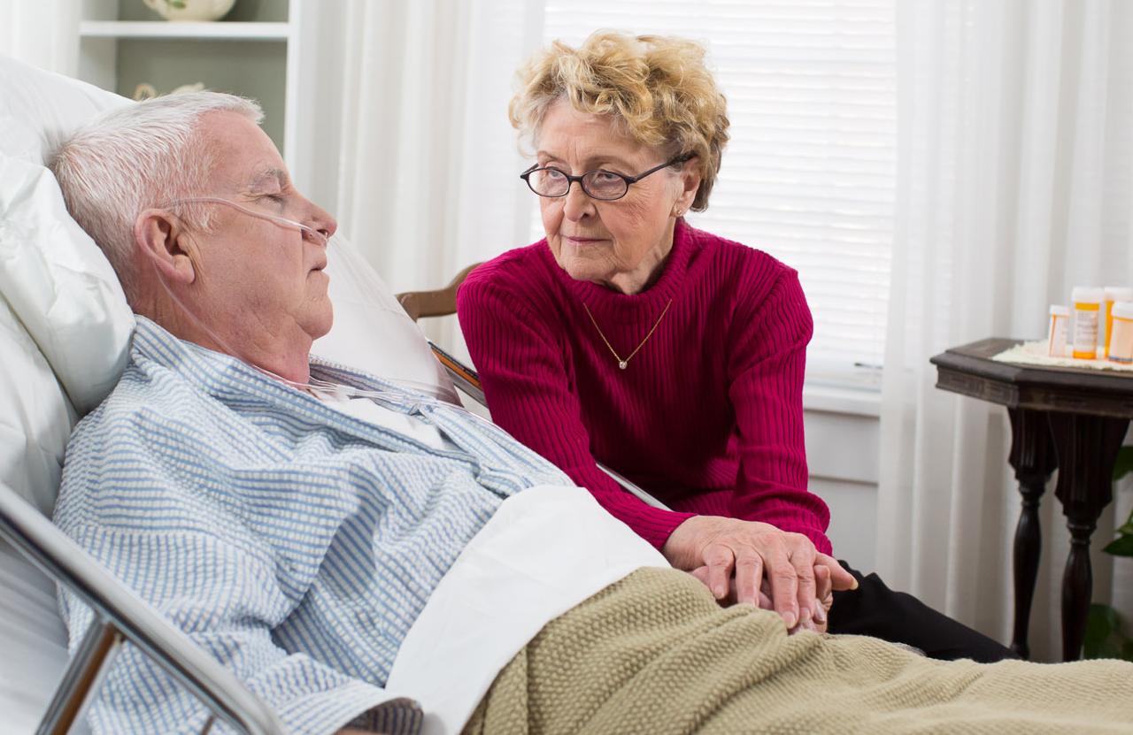 older man with Rotherham CAREGiver at bedside