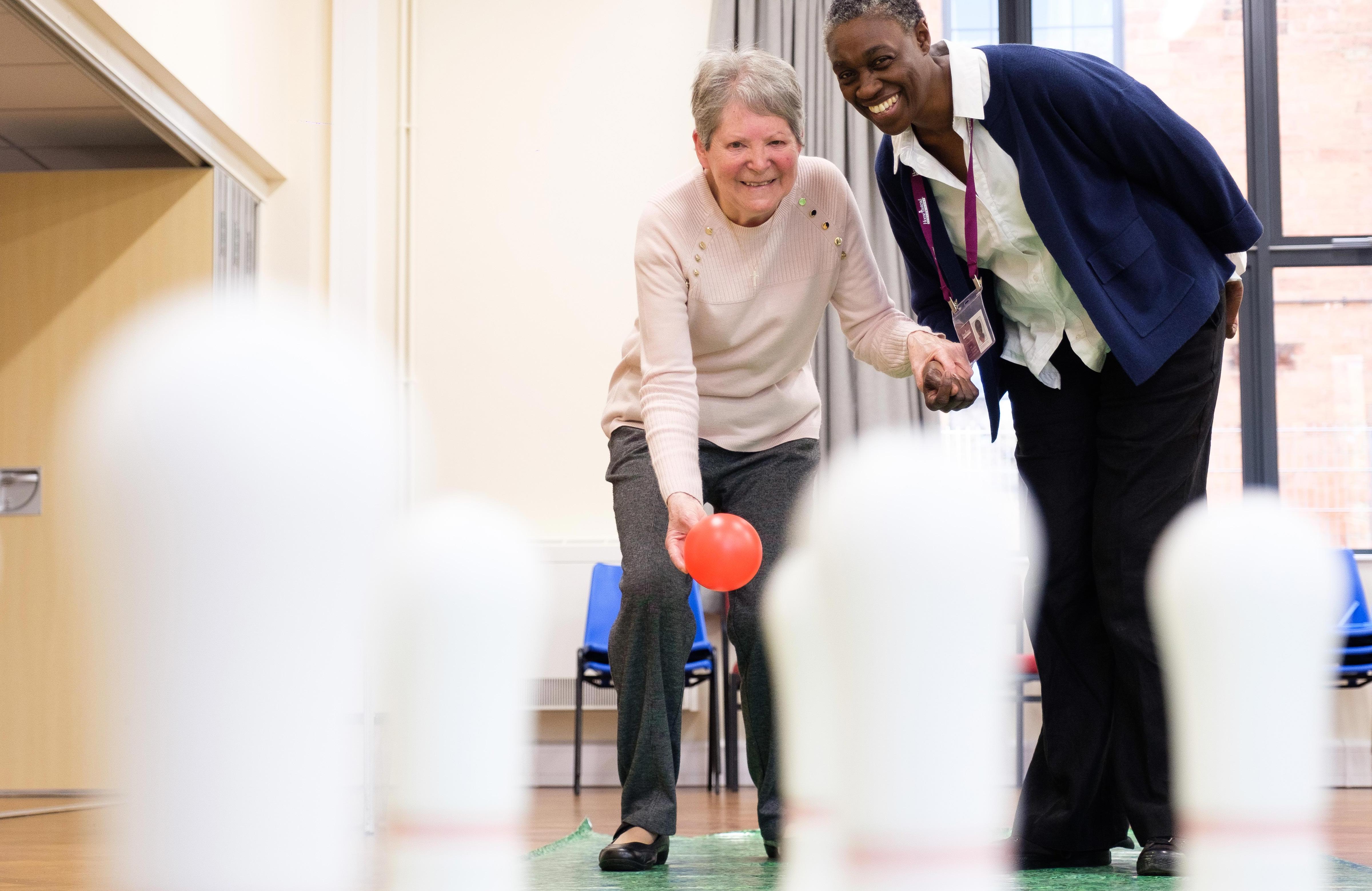 elderly lady with dementia plays bowls