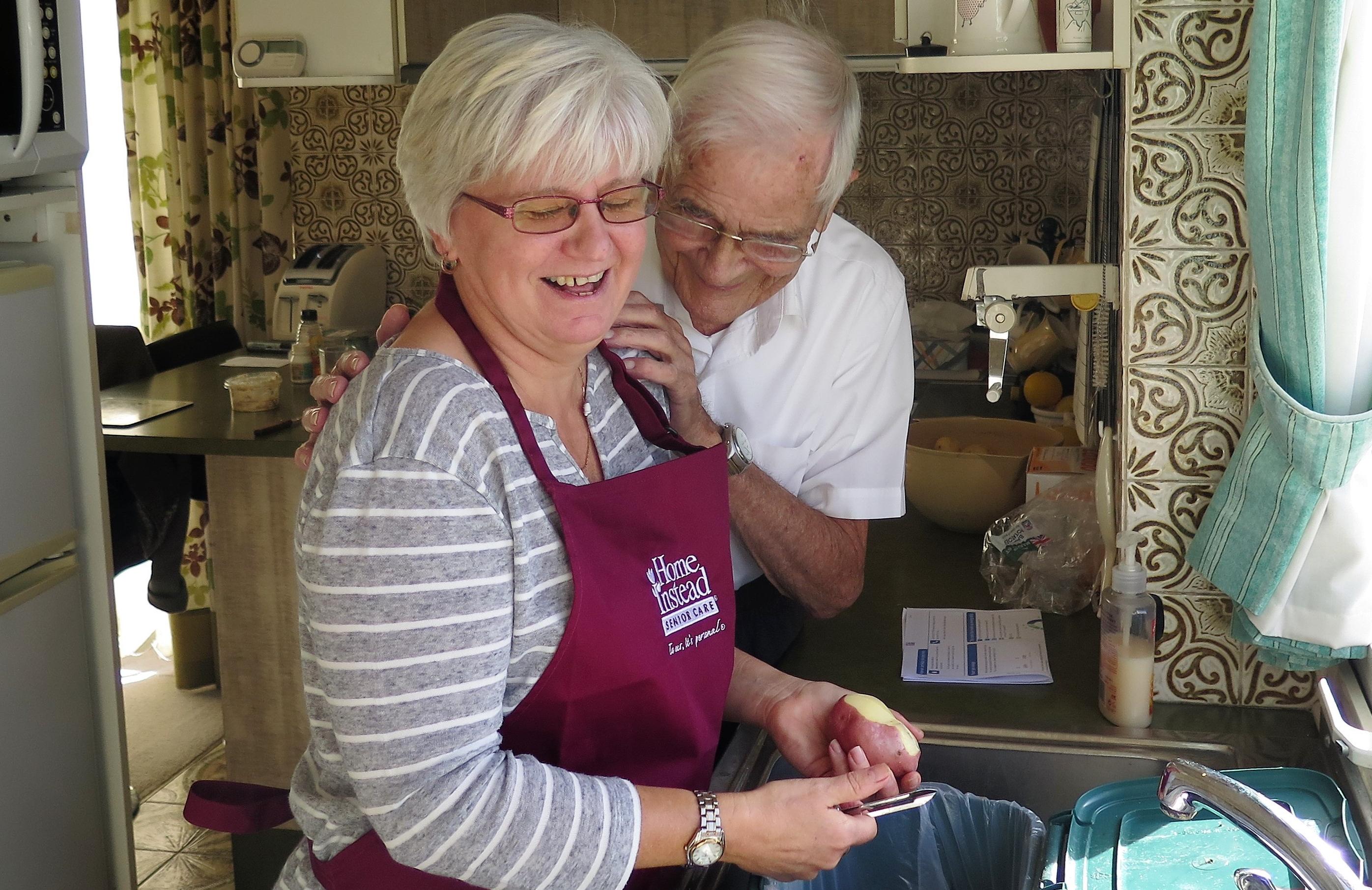 CAREGiver Elaine helping client Ted prepare a meal