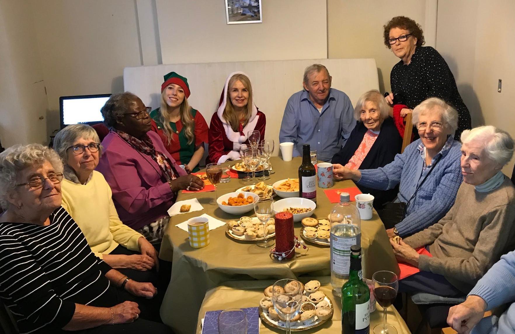 Santa and her elf with the residents of Dulwich Alms Houses