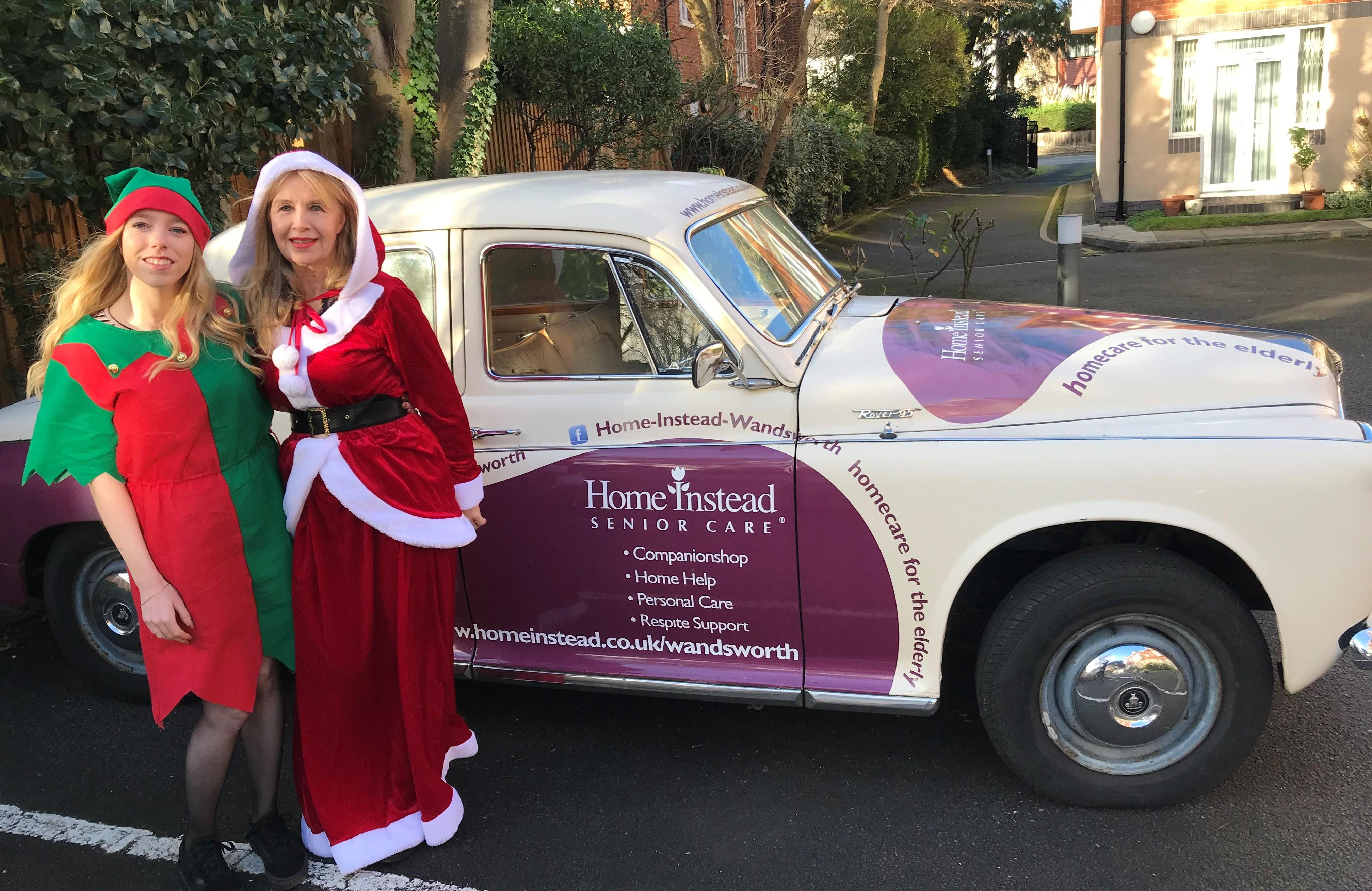 Santa and her Elf arrive in their 1962 Rover, company car