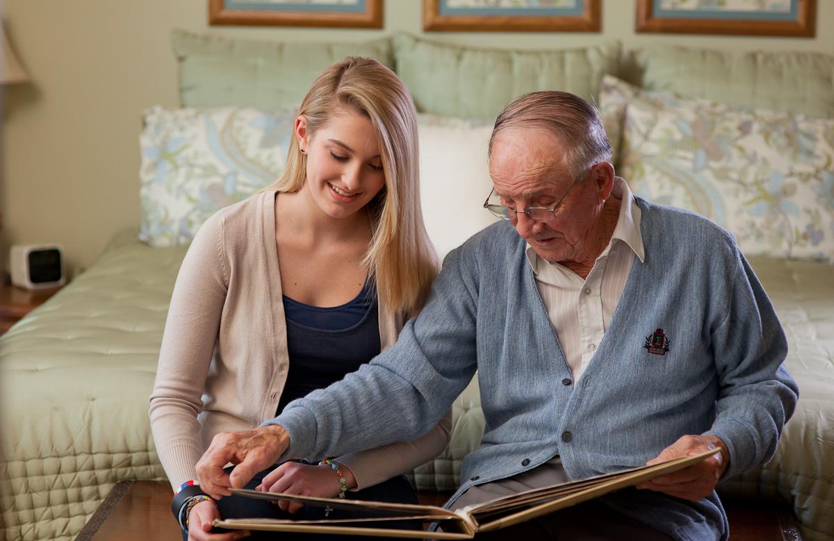 Client and Granddaughter Look at Photo Albums