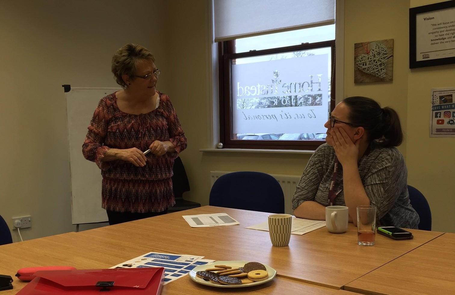 CAREGiver and Office Staff chatting