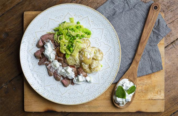 Photo of roast lamb steak with mint and cucumber yoghurt