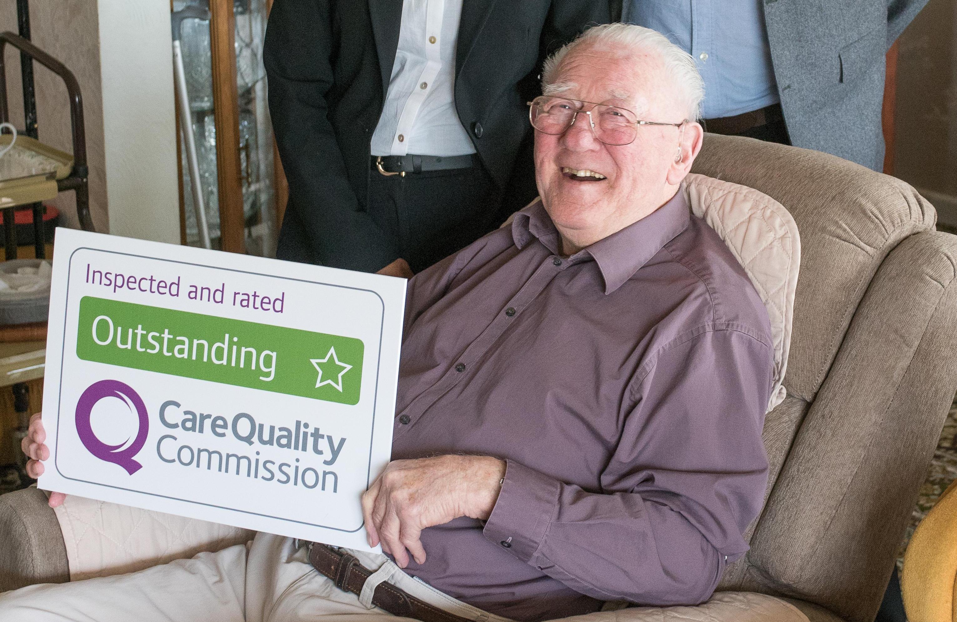 Photo of client with Outstanding sign