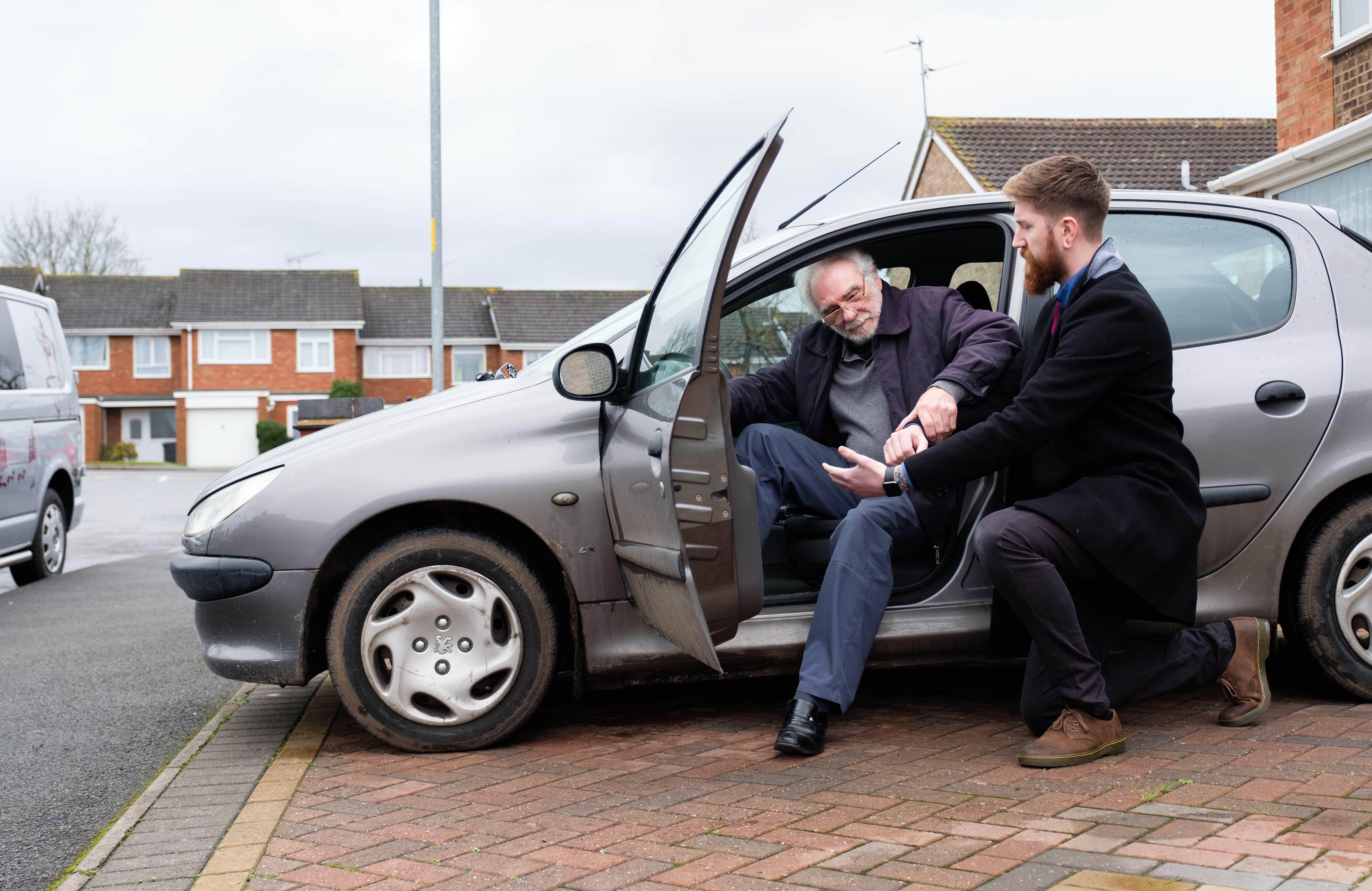Photo of CAREGiver helping client out of car