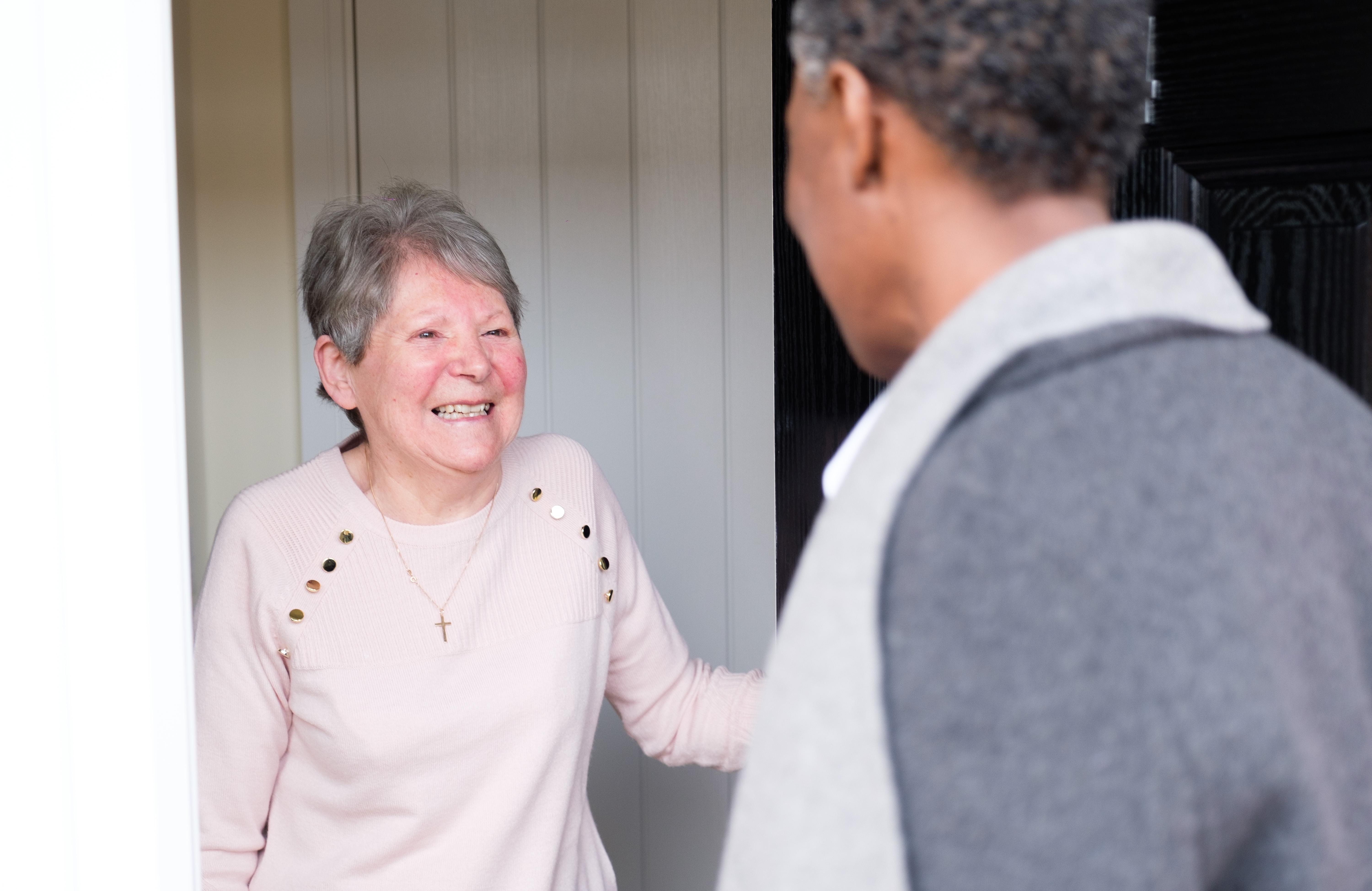 client opens door to caregiver