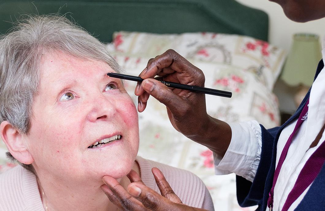 CAREGiver doing Clients Make-Up